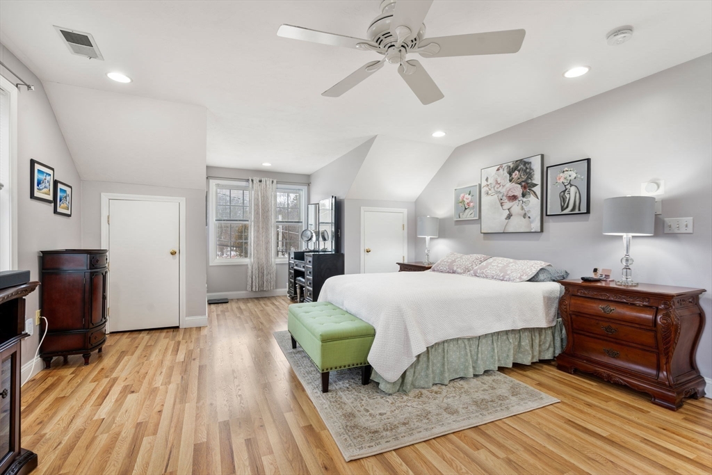 21 Hartwell Place, Unit 21 Canton, MA 02021 - Photo 17 of 33 a spacious bedroom with a bed and a chandelier