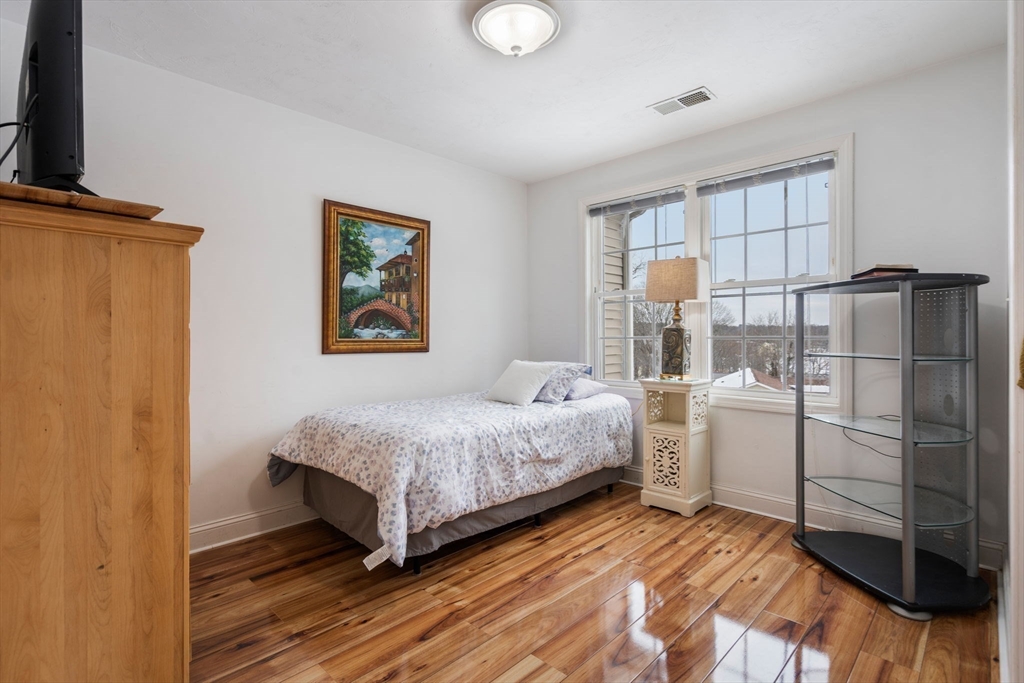 21 Hartwell Place, Unit 21 Canton, MA 02021 - Photo 22 of 33 a bedroom with a bed and a window