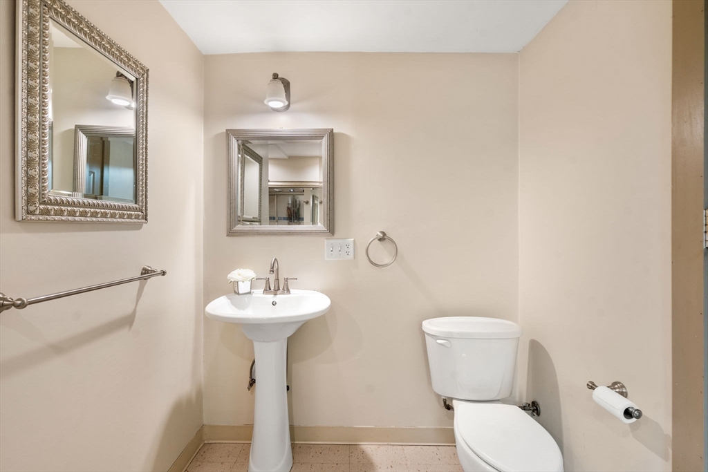 21 Hartwell Place, Unit 21 Canton, MA 02021 - Photo 29 of 33 a bathroom with a toilet sink and mirror