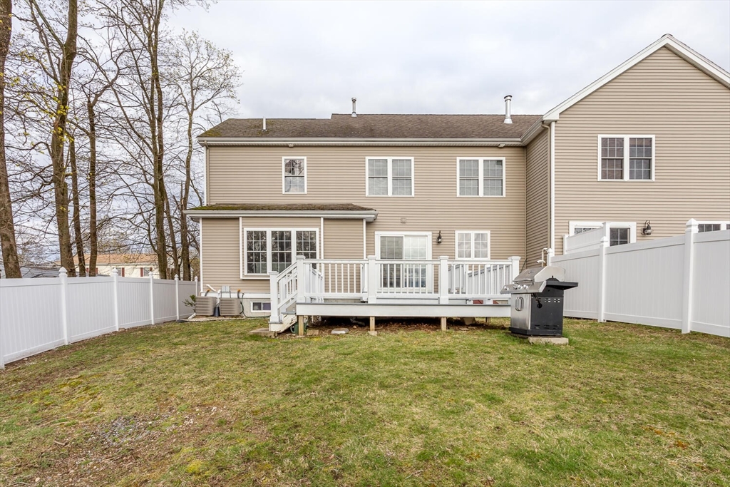 21 Hartwell Place, Unit 21 Canton, MA 02021 - Photo 32 of 33 a front view of a house with a garden and yard