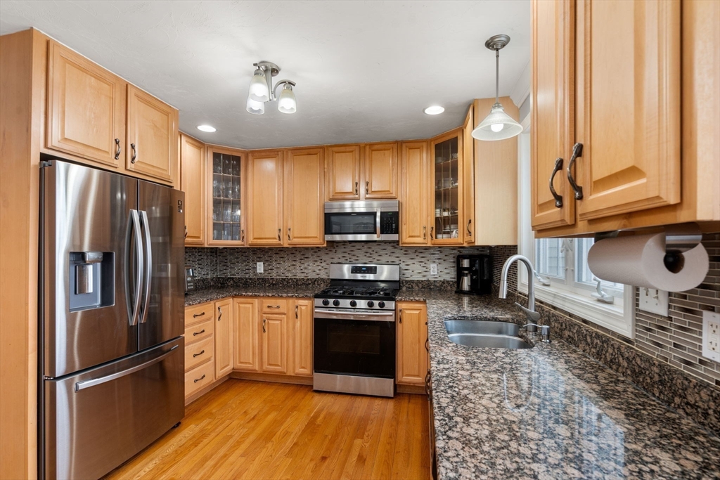 21 Hartwell Place, Unit 21 Canton, MA 02021 - Photo 6 of 33 a kitchen with granite countertop a refrigerator stove and sink