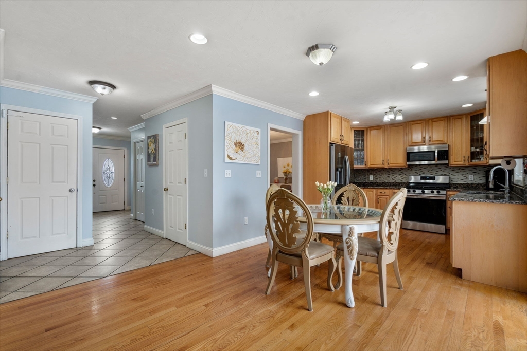 21 Hartwell Place, Unit 21 Canton, MA 02021 - Photo 9 of 33 a view of a dining room with furniture and wooden floor