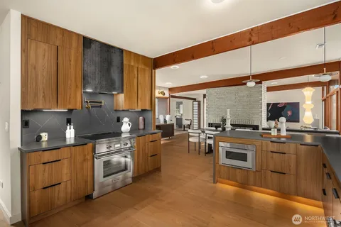 a kitchen with appliances a sink and cabinets
