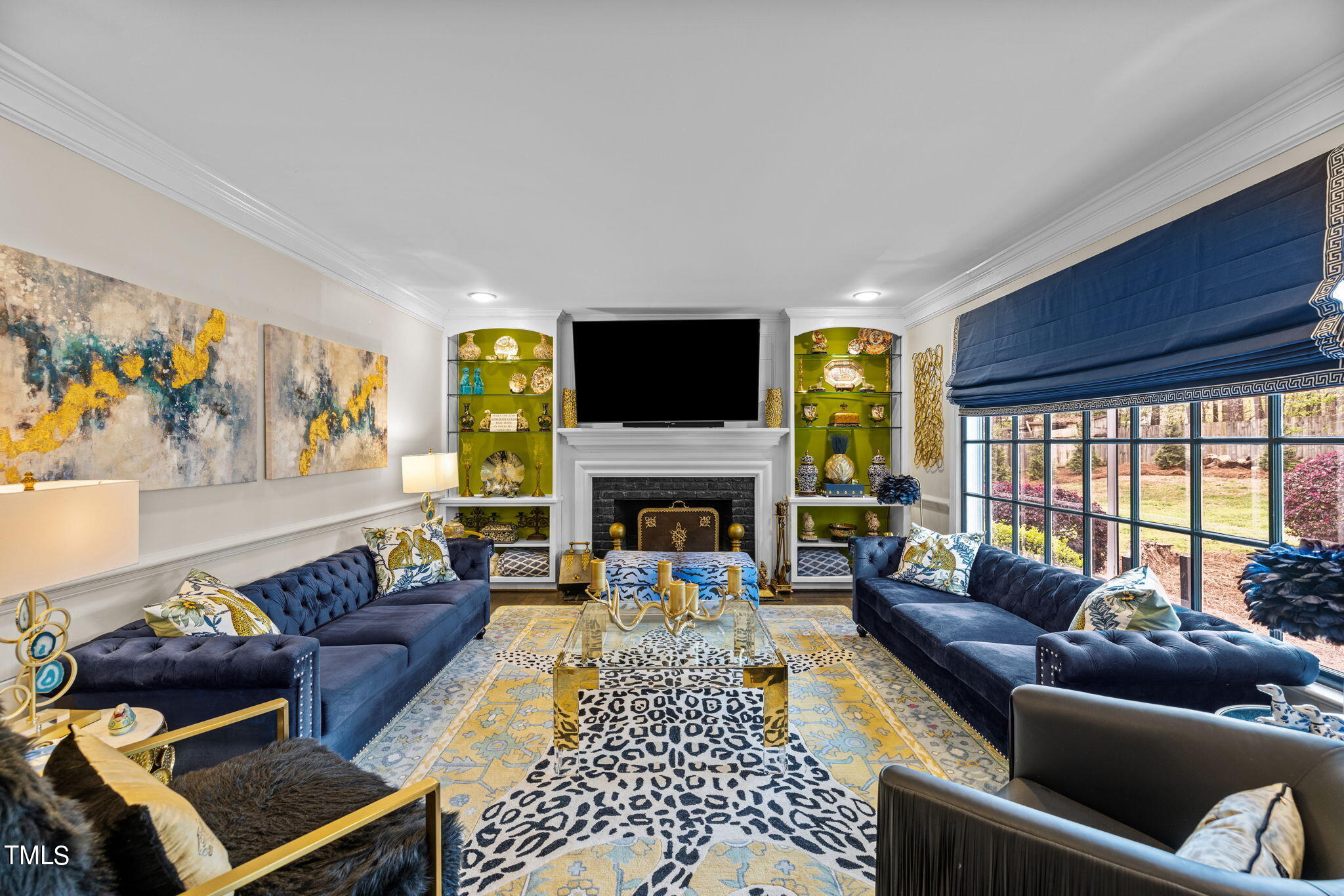 7201 Birchbark Court Raleigh, NC 27615 - Photo 23 of 52 a living room with furniture a flat screen tv and a fireplace
