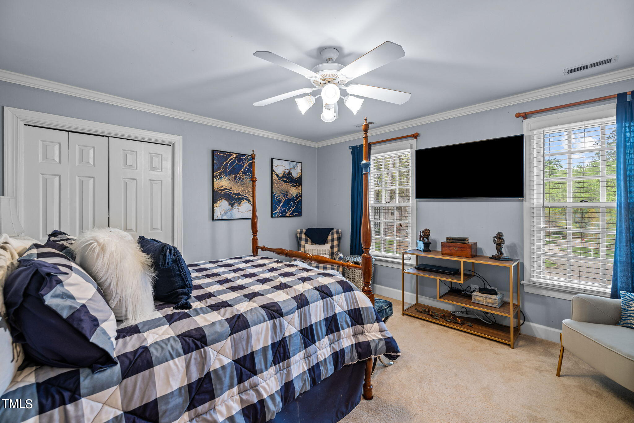 7201 Birchbark Court Raleigh, NC 27615 - Photo 37 of 52 a bedroom with a bed and a flat screen tv