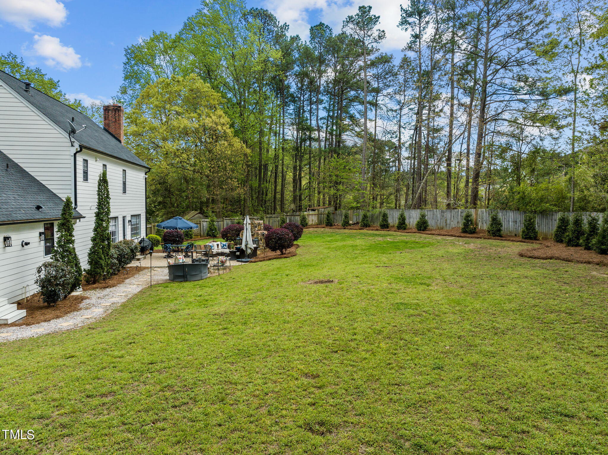 7201 Birchbark Court Raleigh, NC 27615 - Photo 47 of 52 a view of a patio with table and chairs under an umbrella