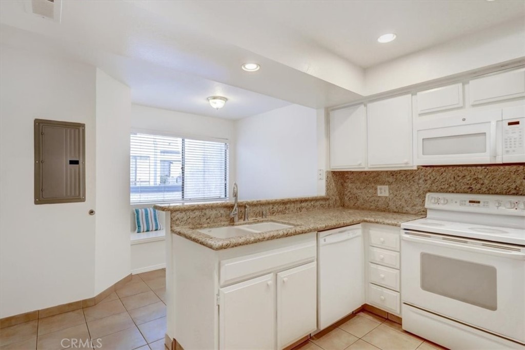 1333 Valley View Road, Unit 18 Glendale, CA 91202 - Photo 11 of 52 a kitchen with granite countertop white cabinets and white appliances