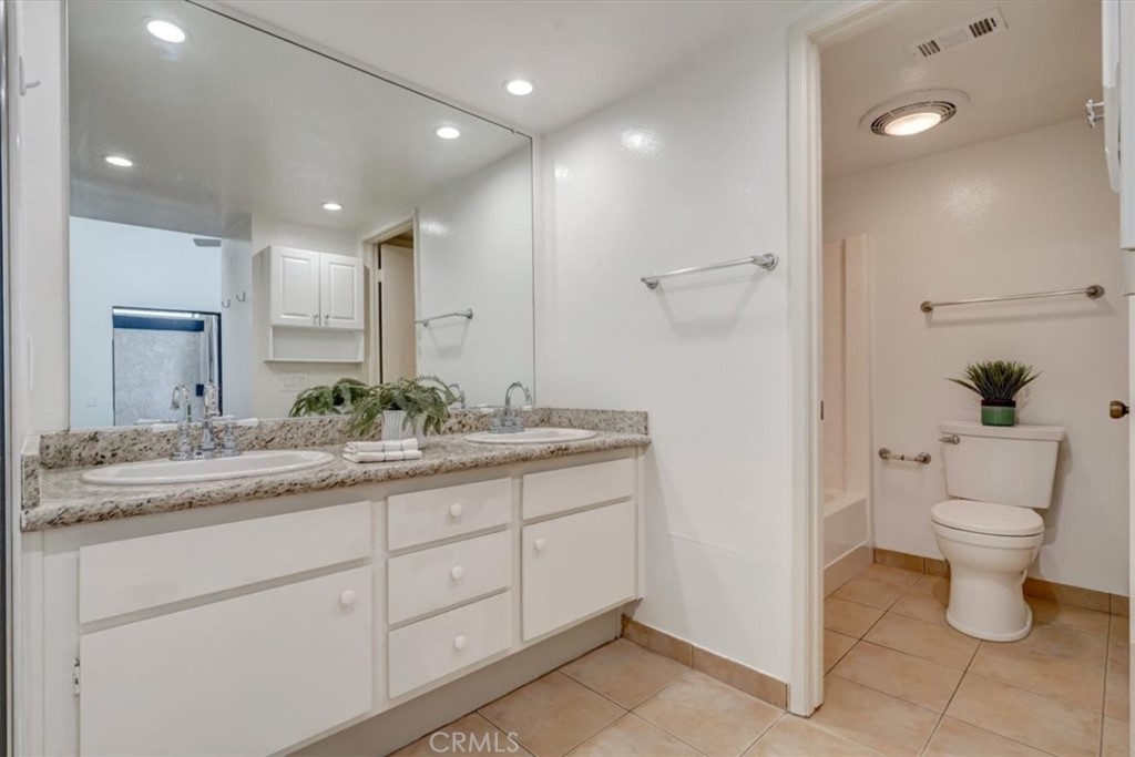1333 Valley View Road, Unit 18 Glendale, CA 91202 - Photo 26 of 52 a bathroom with a granite countertop sink a toilet and a mirror