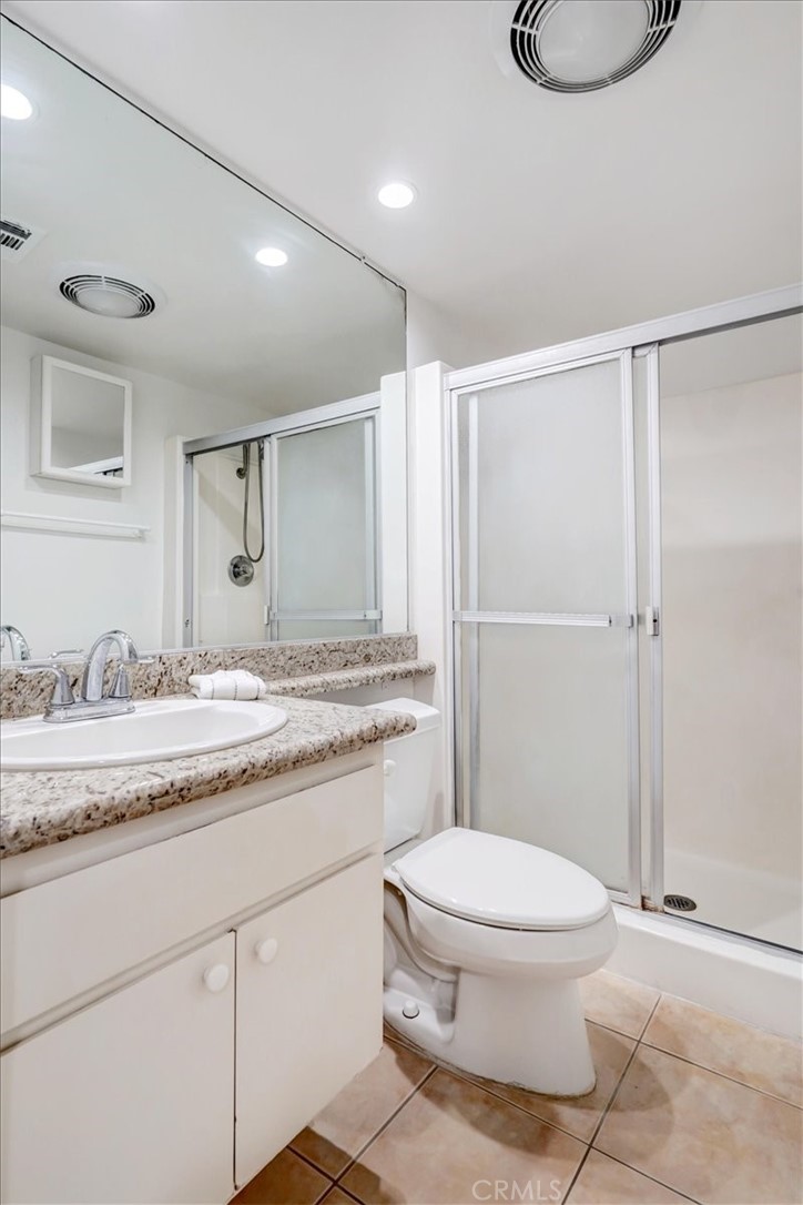 1333 Valley View Road, Unit 18 Glendale, CA 91202 - Photo 37 of 52 a bathroom with a granite countertop sink toilet a mirror and a shower