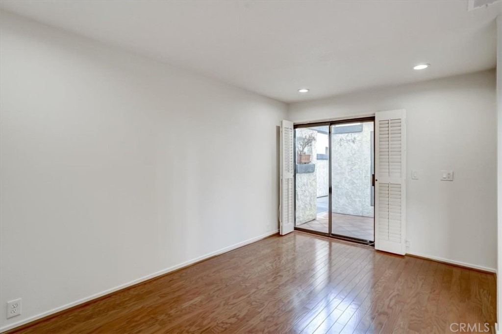 1333 Valley View Road, Unit 18 Glendale, CA 91202 - Photo 39 of 52 a view of an empty room with wooden floor and a window