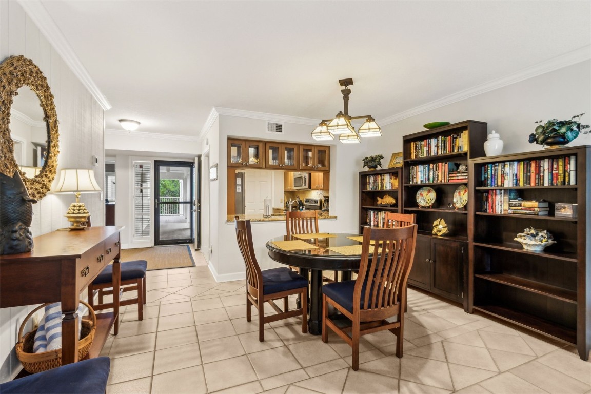 2123 Beachwood Road, Unit 2123 Fernandina Beach, FL 32034 - Photo 11 of 64 a view of a dining room with furniture and chandelier