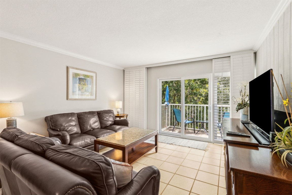 2123 Beachwood Road, Unit 2123 Fernandina Beach, FL 32034 - Photo 14 of 64 a living room with furniture a flat screen tv and a large window