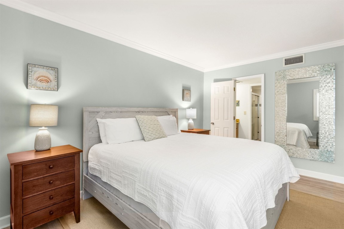 2123 Beachwood Road, Unit 2123 Fernandina Beach, FL 32034 - Photo 21 of 64 a bedroom with a bed and a lamp on table