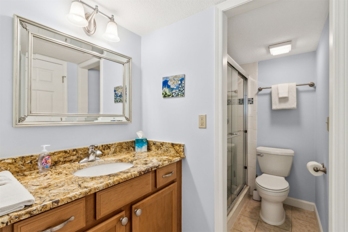 2123 Beachwood Road, Unit 2123 Fernandina Beach, FL 32034 - Photo 22 of 64 a bathroom with a granite countertop sink and a toilet
