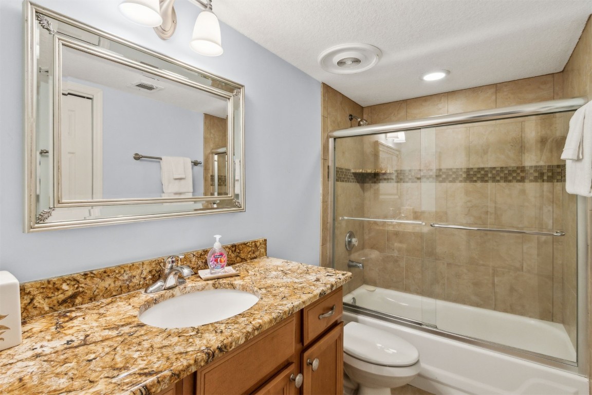 2123 Beachwood Road, Unit 2123 Fernandina Beach, FL 32034 - Photo 26 of 64 a bathroom with a granite countertop sink toilet mirror and shower