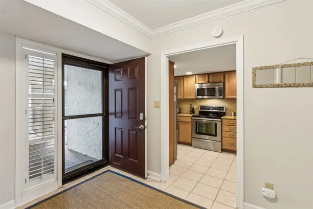 a kitchen with granite countertop a stove top oven microwave and cabinets