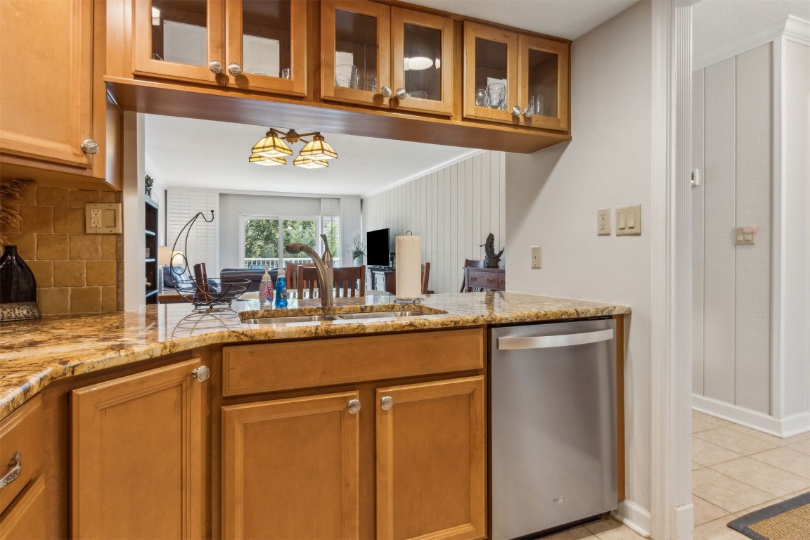 2123 Beachwood Road, Unit 2123 Fernandina Beach, FL 32034 - Photo 9 of 64 a kitchen with stainless steel appliances granite countertop a sink and dishwasher with white cabinets