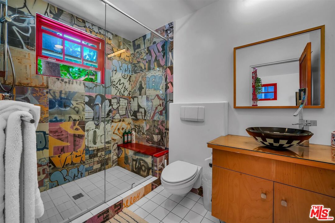 2419 Ocean Avenue Venice, CA 90291 - Photo 16 of 41 a bathroom with a toilet a sink and a shower curtain