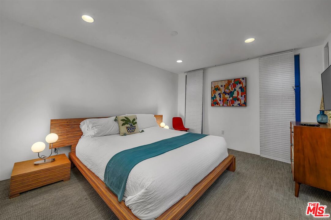 2419 Ocean Avenue Venice, CA 90291 - Photo 21 of 41 a bedroom with a bed and a flat screen tv