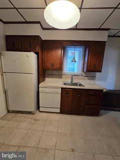 a kitchen with a cabinets and white appliances