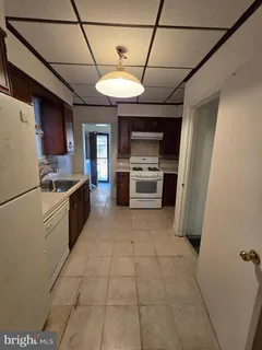 a kitchen with stainless steel appliances granite countertop a refrigerator a stove top oven a sink and dishwasher