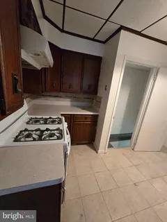 a white stove top oven sitting inside of a kitchen