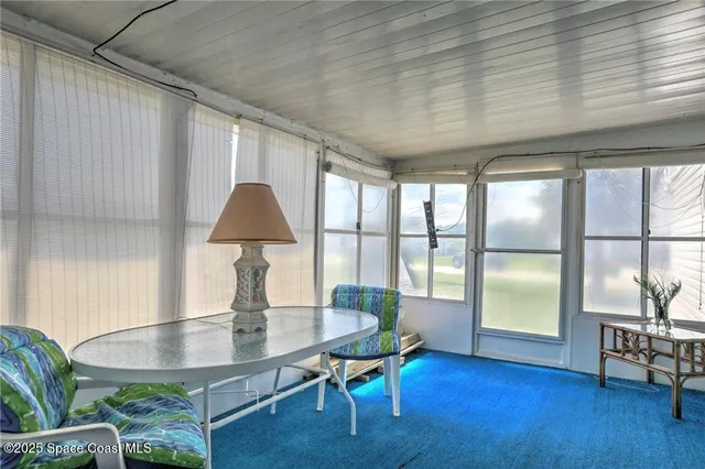 an aerial view of a houses with a yard