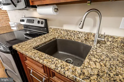a close view of a sink a counter and appliances in the kitchen