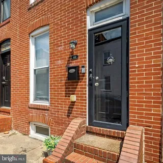 a brick house with a door and a window