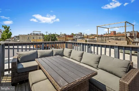 a view of a balcony with wooden benches