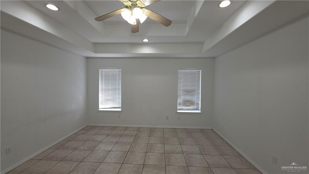 2014 Northgate Circle Weslaco, TX 78599 - Photo 15 of 23 Spare room featuring a raised ceiling, light tile patterned flooring, ceiling fan, and recessed lighting