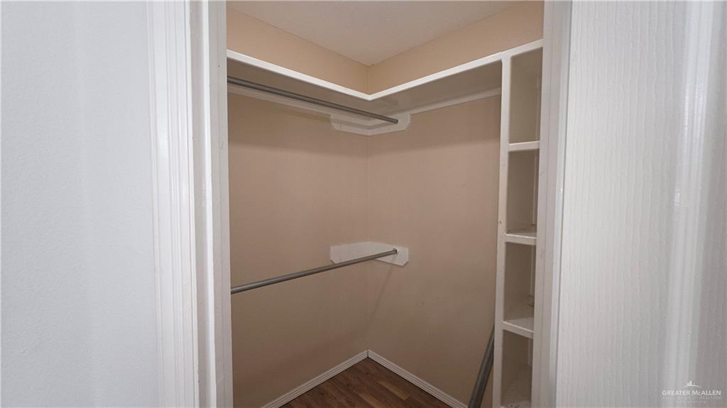 2014 Northgate Circle Weslaco, TX 78599 - Photo 19 of 23 Walk in closet featuring dark wood-type flooring