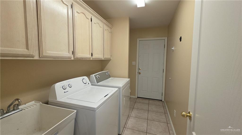 2014 Northgate Circle Weslaco, TX 78599 - Photo 20 of 23 Laundry area featuring light tile patterned floors, separate washer and dryer, and cabinet space