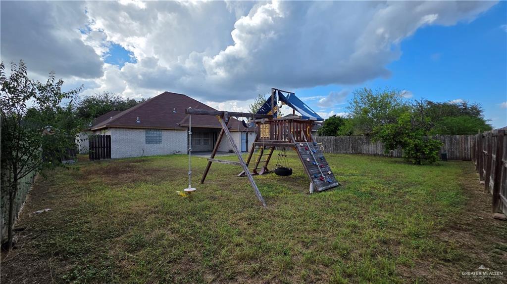 2014 Northgate Circle Weslaco, TX 78599 - Photo 23 of 23 View of jungle gym featuring a fenced backyard