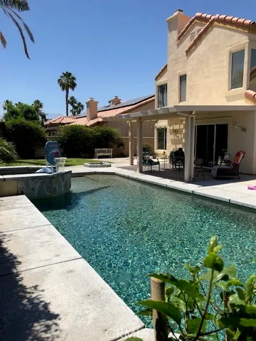 a view of a swimming pool with a yard