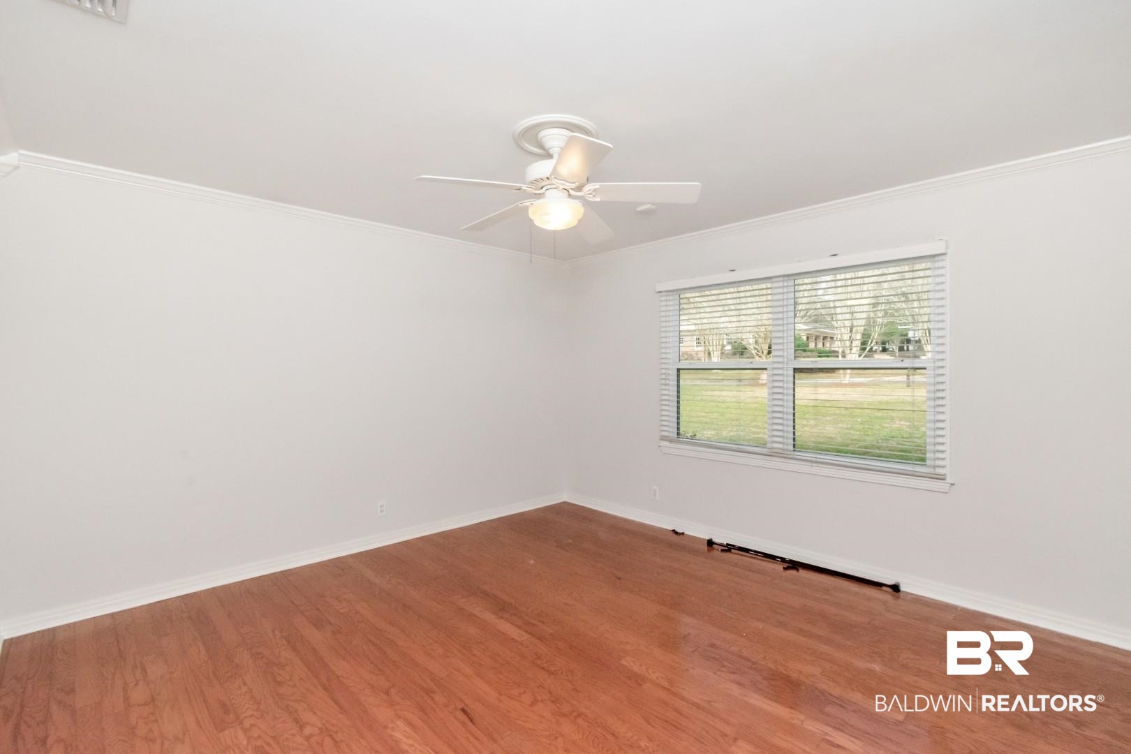 231 Rochester Road Mobile, AL 36608 - Photo 32 of 51 Unfurnished room with wood finished floors, crown molding, and a ceiling fan