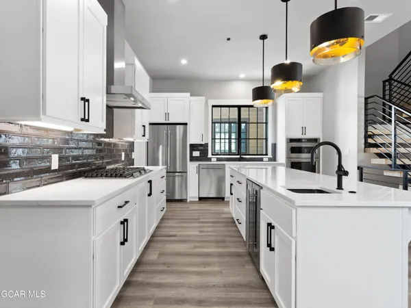 a kitchen with stainless steel appliances kitchen island granite countertop a sink and cabinets