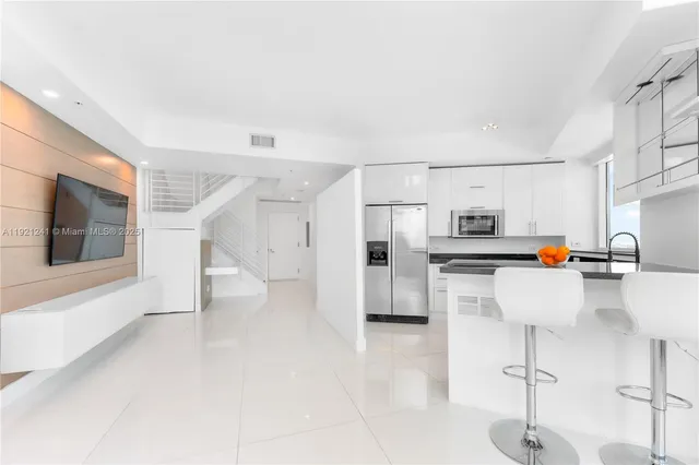 a view of kitchen with furniture and refrigerator
