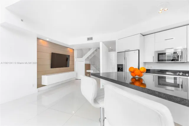 a kitchen with stainless steel appliances granite countertop a sink and a microwave