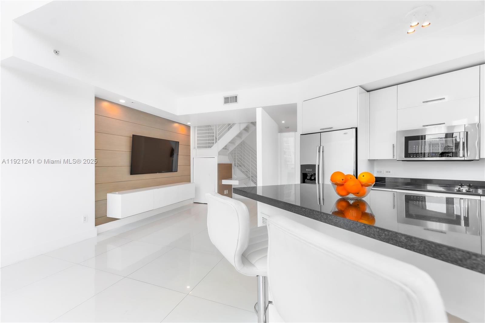 60 Southwest 13th Street, Unit 2626 Miami, FL 33130 - Photo 13 of 48 a kitchen with stainless steel appliances granite countertop a sink and a microwave