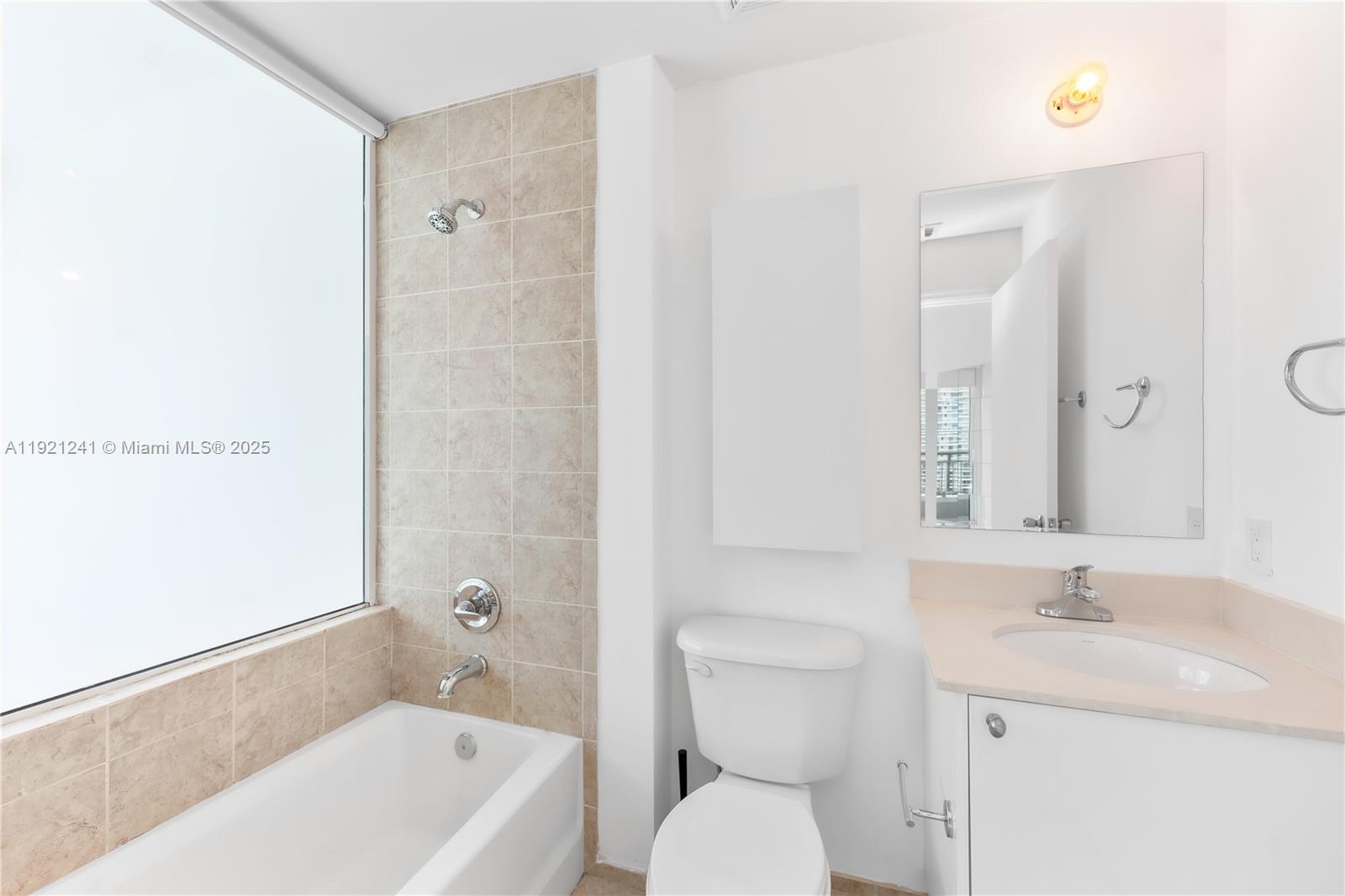 60 Southwest 13th Street, Unit 2626 Miami, FL 33130 - Photo 28 of 48 a bathroom with a sink a toilet and shower