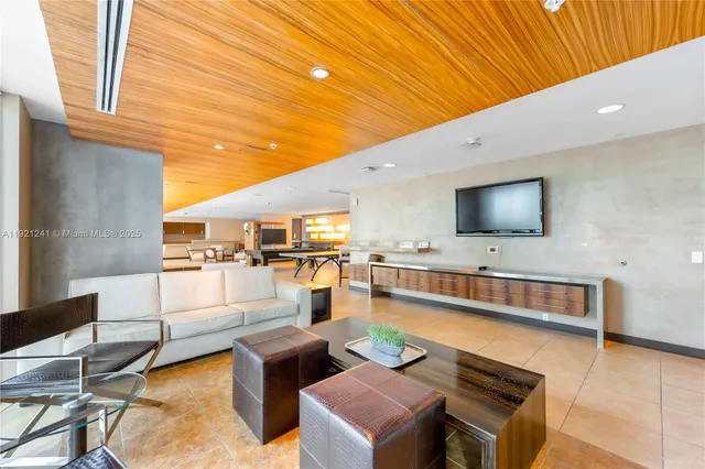 a dining hall with a dining table and chairs with a large window