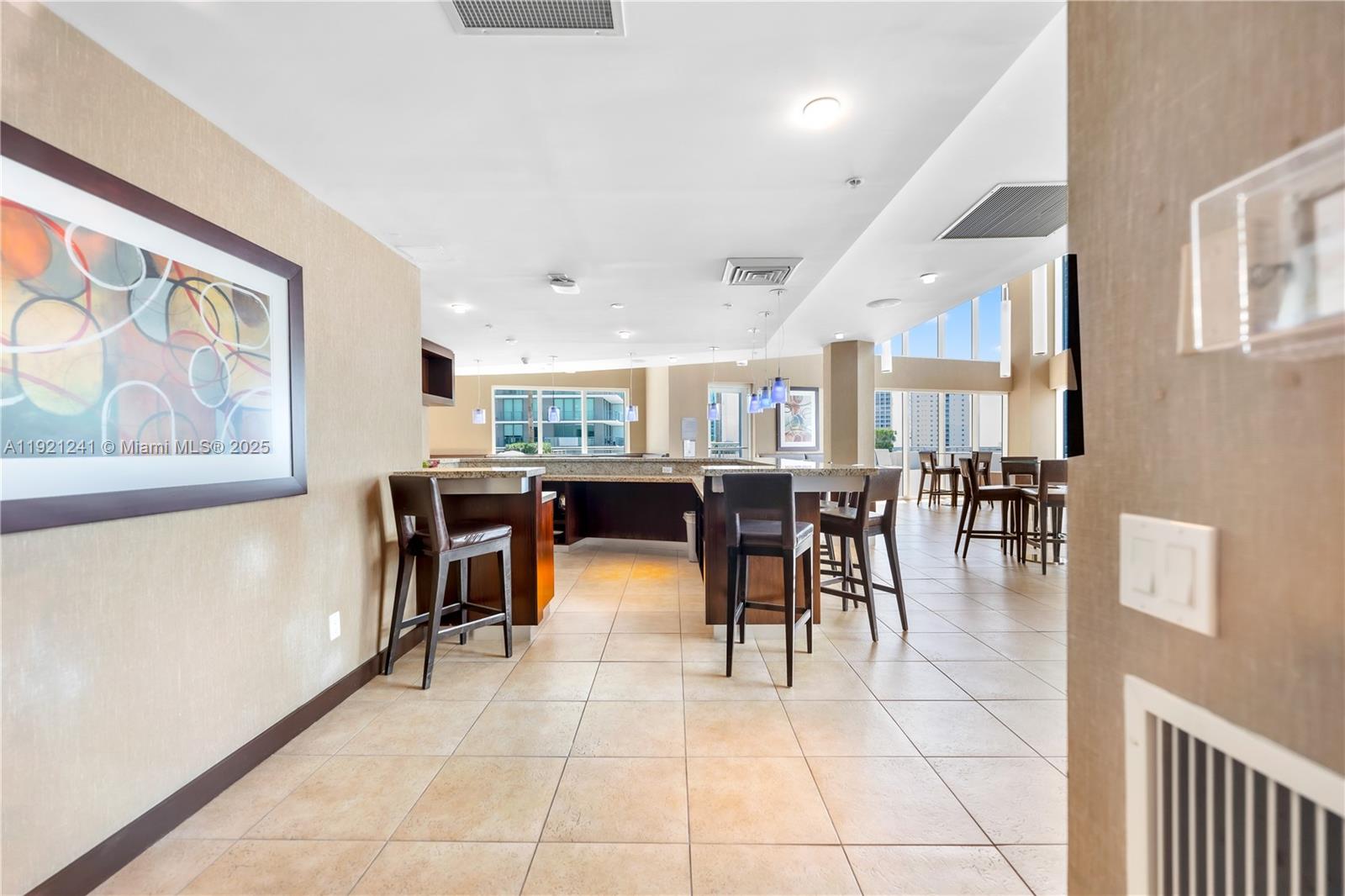 60 Southwest 13th Street, Unit 2626 Miami, FL 33130 - Photo 40 of 48 a dining hall with a dining table and chairs with a large window
