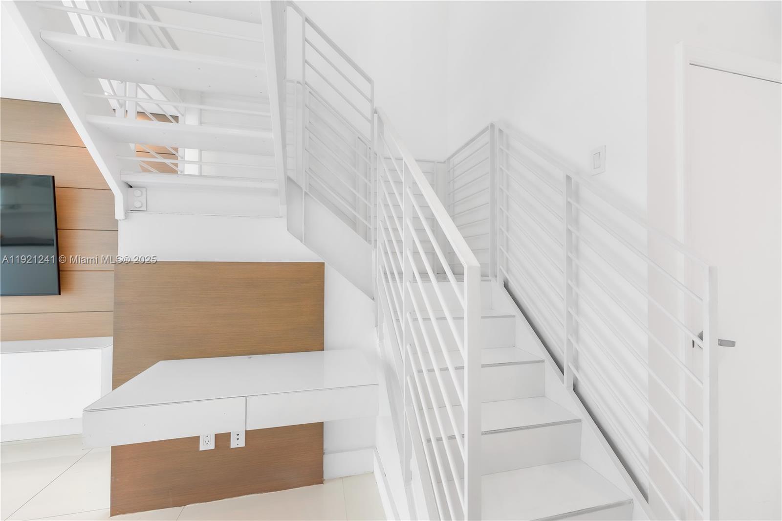 60 Southwest 13th Street, Unit 2626 Miami, FL 33130 - Photo 6 of 48 a view of staircase with white walls