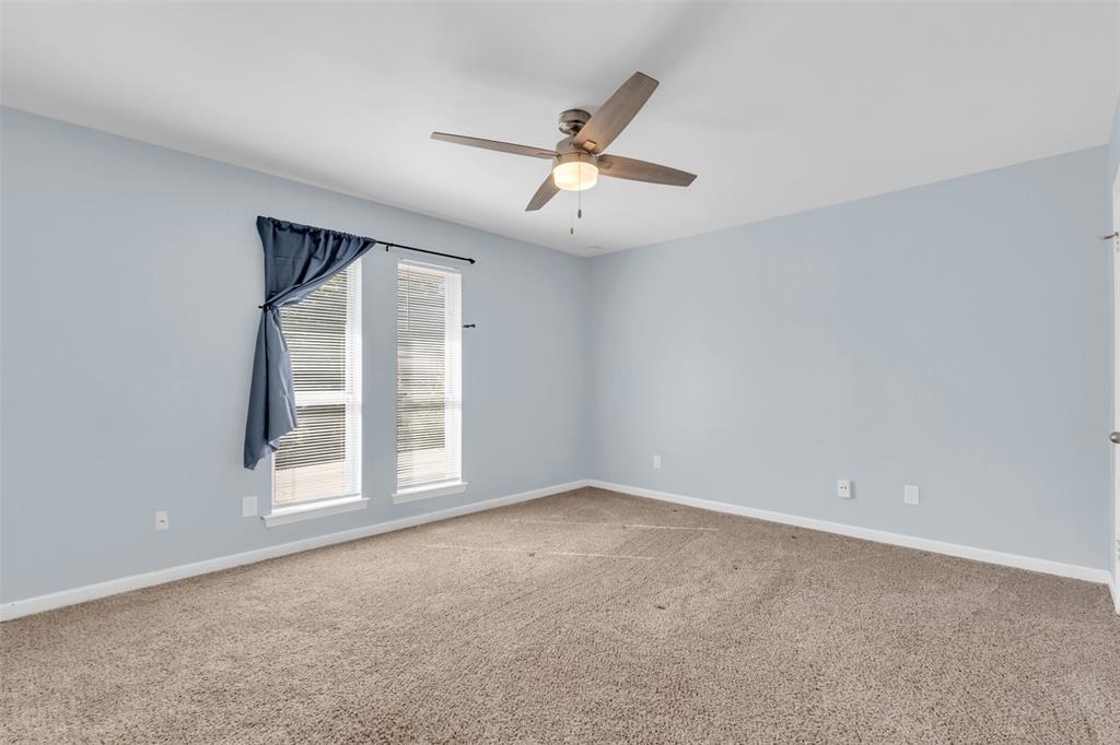 4688 Matilda Street, Unit H Dallas, TX 75206 - Photo 13 of 20 an empty room with windows and ceiling fan