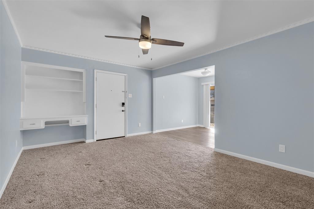 4688 Matilda Street, Unit H Dallas, TX 75206 - Photo 3 of 20 a view of a big room with chandelier and white walls