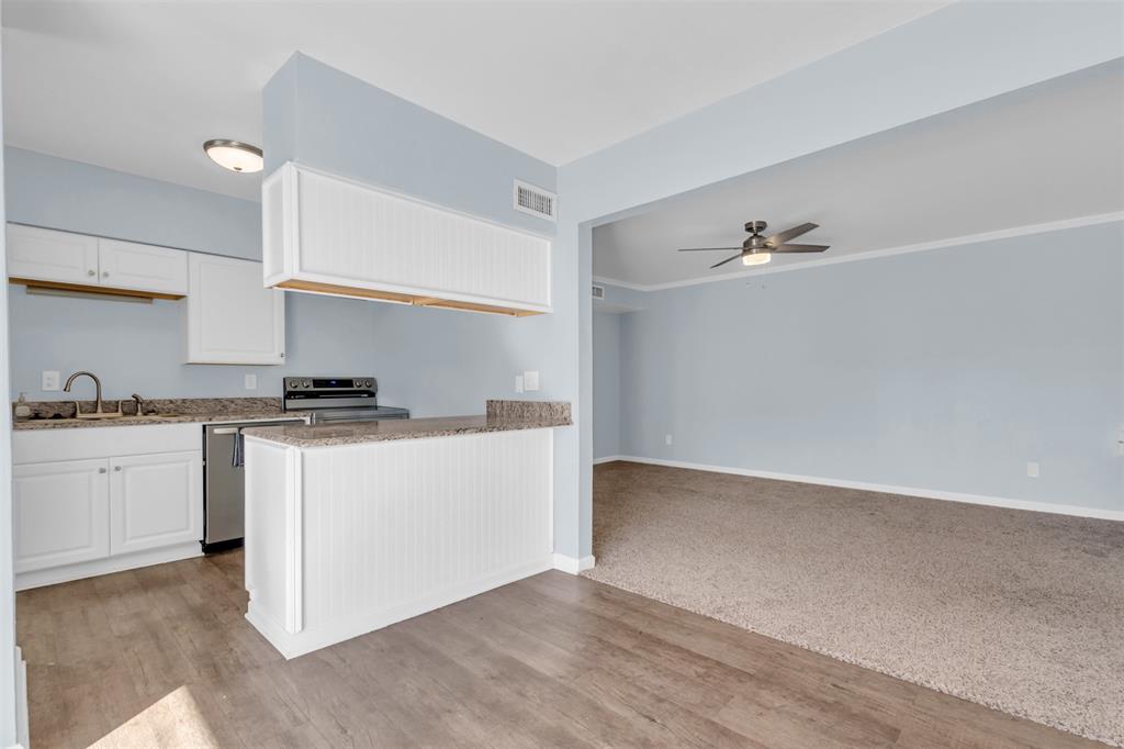 4688 Matilda Street, Unit H Dallas, TX 75206 - Photo 7 of 20 a kitchen with granite countertop white cabinets and white appliances