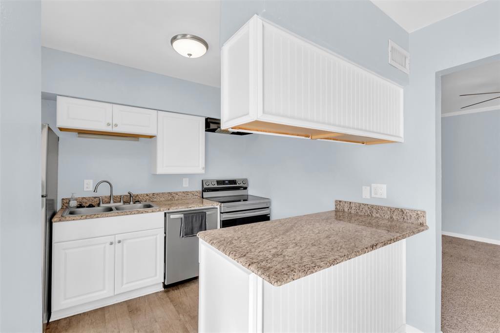 4688 Matilda Street, Unit H Dallas, TX 75206 - Photo 8 of 20 a kitchen with stainless steel appliances granite countertop a sink stove and cabinets