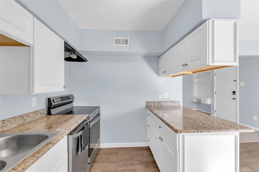 4688 Matilda Street, Unit H Dallas, TX 75206 - Photo 9 of 20 a kitchen with granite countertop a sink and dishwasher a stove with wooden floor