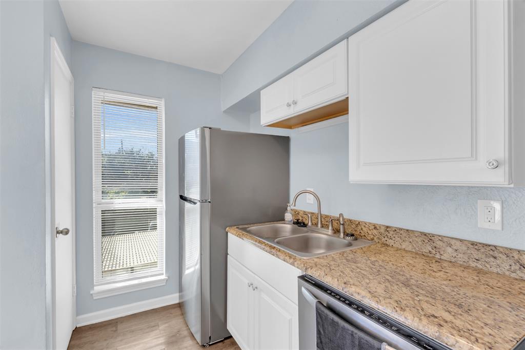 4688 Matilda Street, Unit H Dallas, TX 75206 - Photo 10 of 20 a kitchen with a sink and cabinets